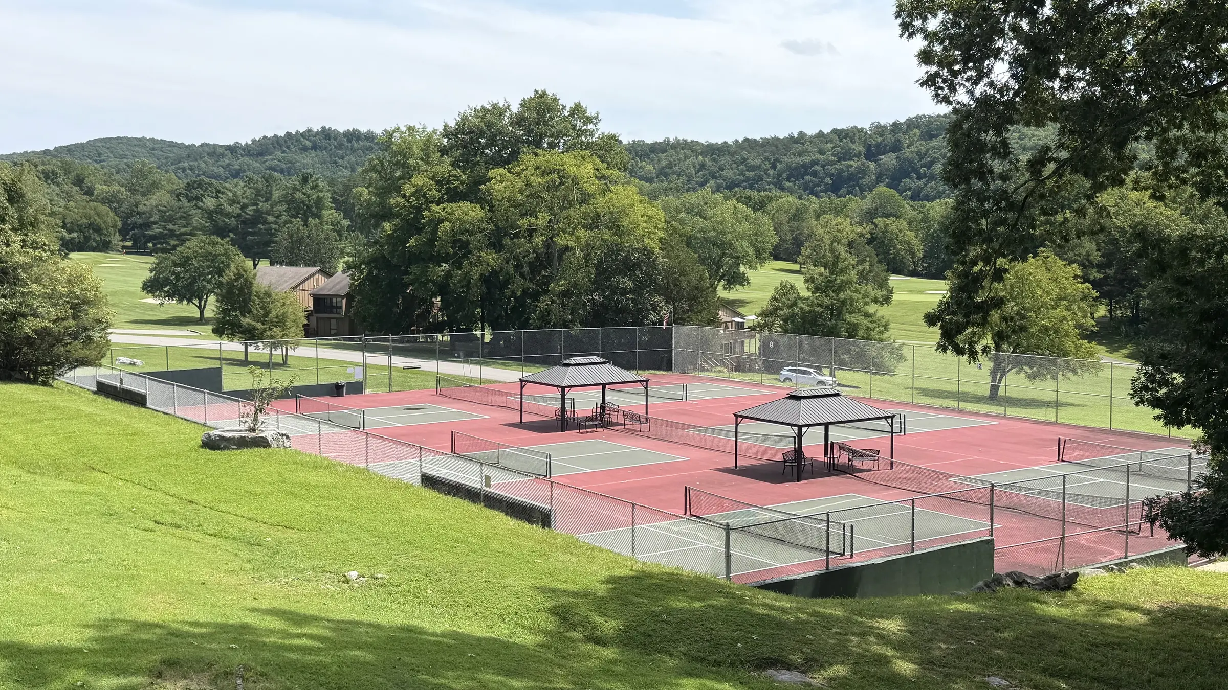 Community sports courts surrounded by wooded hills at Woodson Bend
